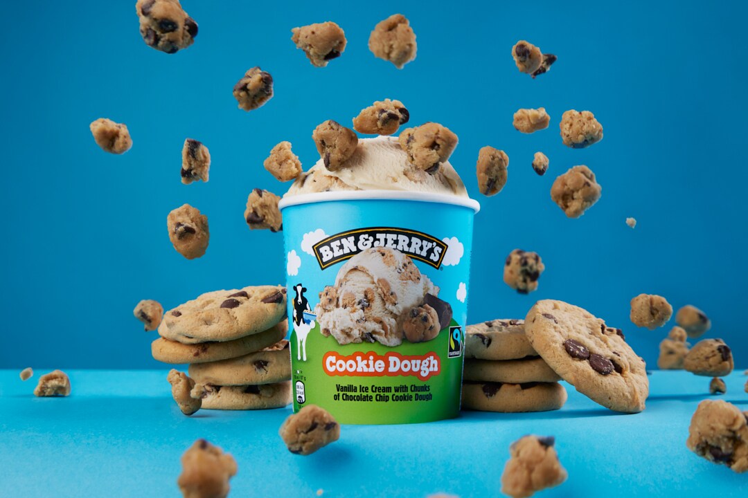 A pint of Cookie Dough ice cream surrounded by cookies